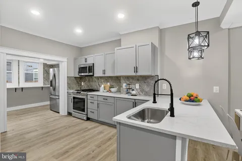 a kitchen that has a lot of cabinets and appliances