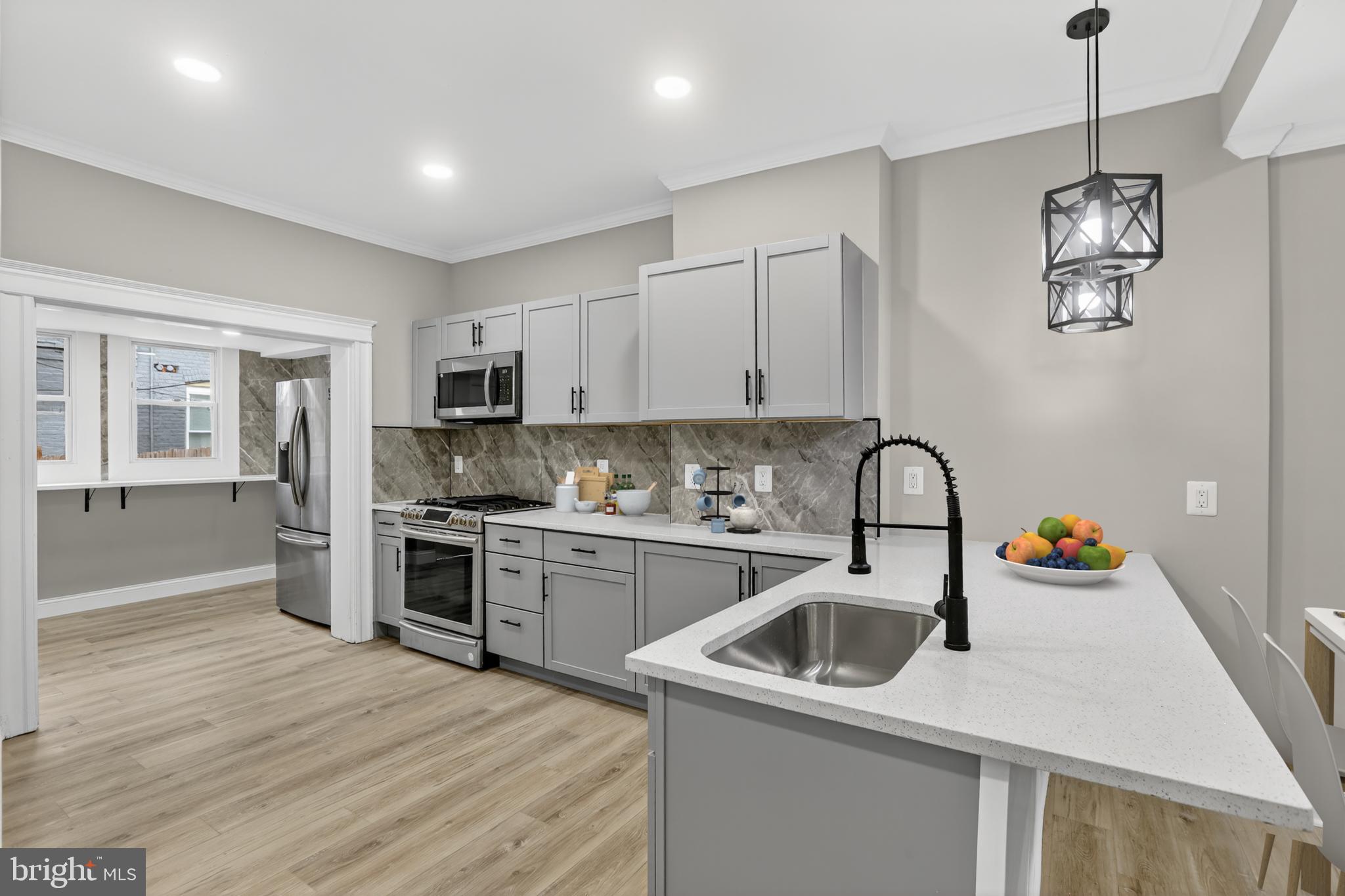 a kitchen that has a lot of cabinets and appliances