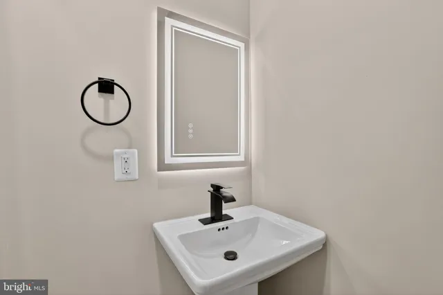 a bathroom with a sink mirror and vanity