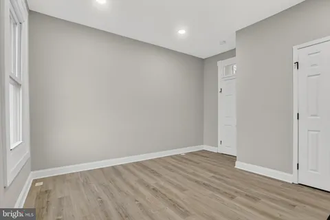 an empty room with wooden floor