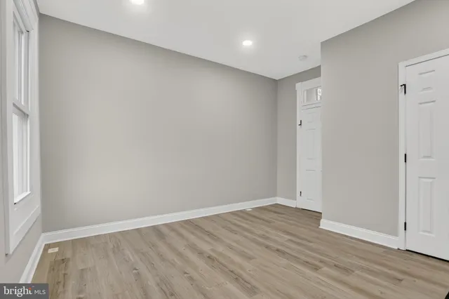 an empty room with wooden floor