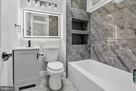 a bathroom with a toilet a sink and bathtub