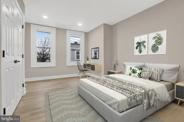 a bedroom with a bed and a painting on the wall