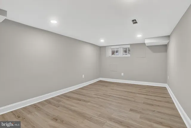 a view of a blue house with a wooden fence