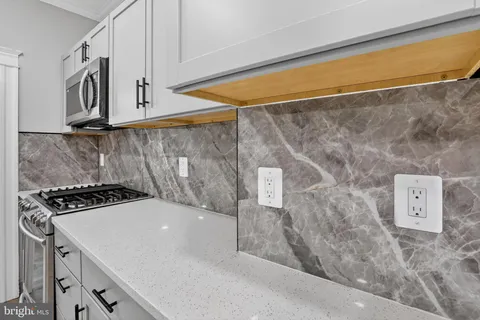 a kitchen with a stove and a sink