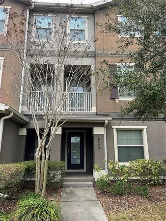 front view of a house with a tree
