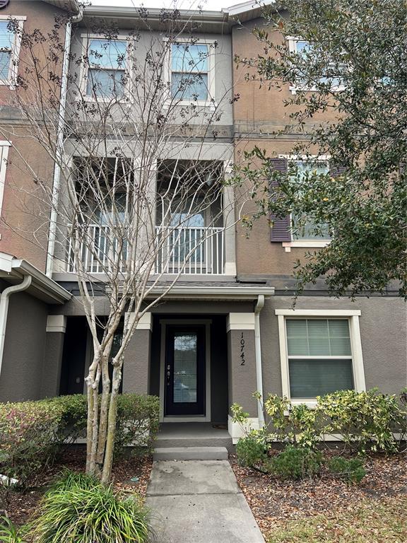 front view of a house with a tree