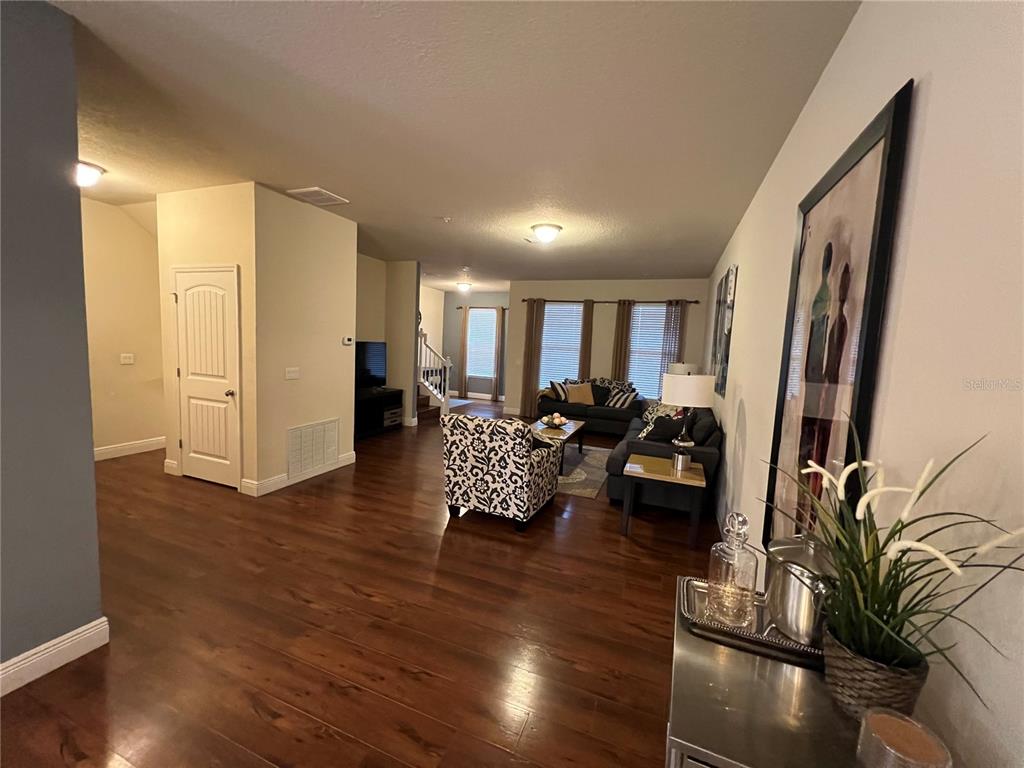 10742 Sunset Ridge Lane Orlando, FL 32832 - Photo 11 of 40 a living room with furniture and a wooden floor