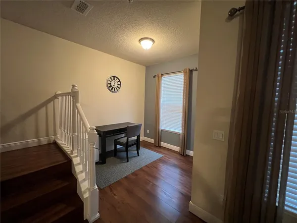 a bedroom with a bed and a painting on the wall