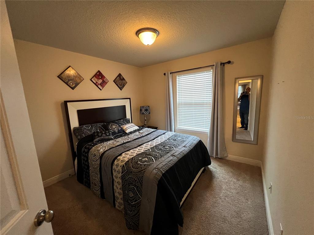 10742 Sunset Ridge Lane Orlando, FL 32832 - Photo 17 of 40 a bedroom with a bed and a painting on the wall