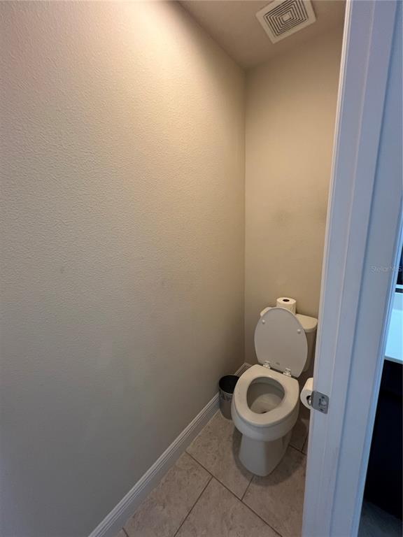 10742 Sunset Ridge Lane Orlando, FL 32832 - Photo 21 of 40 a white toilet sitting in a bathroom