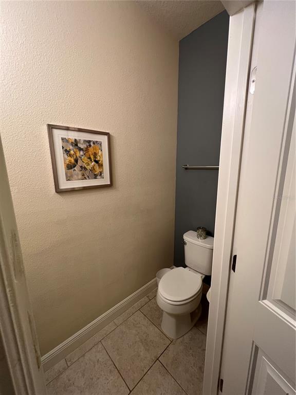 10742 Sunset Ridge Lane Orlando, FL 32832 - Photo 25 of 40 a white toilet sitting next to a small bathroom