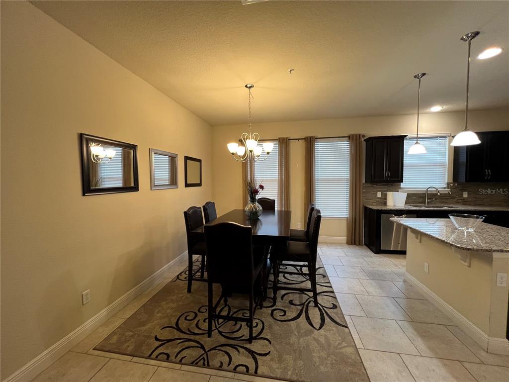 10742 Sunset Ridge Lane Orlando, FL 32832 - Photo 10 of 40 a view of a dining room with furniture