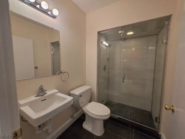 a bathroom with a toilet sink shower and mirror