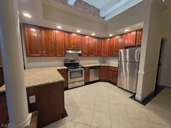 a kitchen with stainless steel appliances granite countertop a refrigerator sink and cabinets
