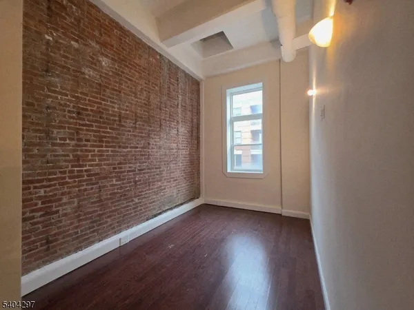 a view of livingroom with window and wooden floor