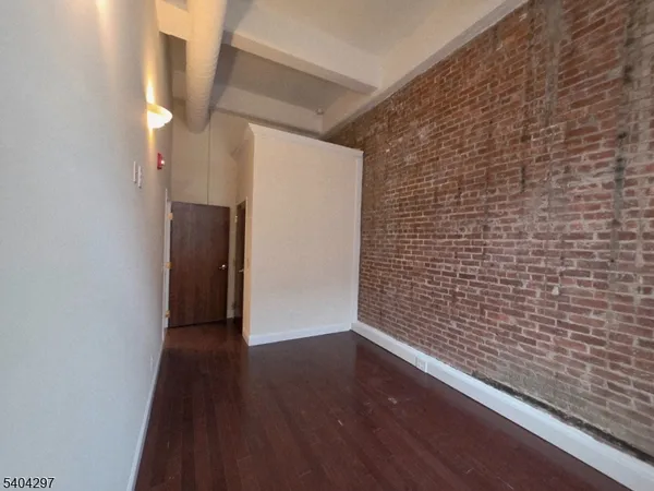 a view of hallway with wooden floor