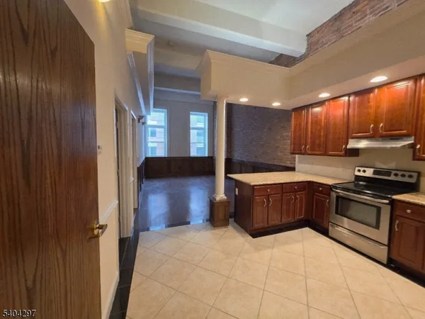 a kitchen with stainless steel appliances granite countertop a stove a sink dishwasher and a refrigerator
