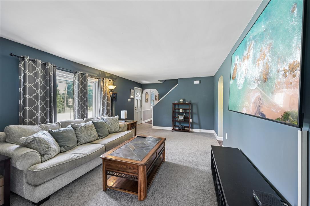 4065 Airport Road Allentown, PA 18109 - Photo 5 of 28 A welcoming living area provides ample space for relaxation and entertaining, with a staircase leading to additional levels.