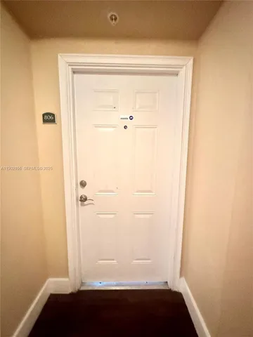 a view of a room with wooden floor and a sink