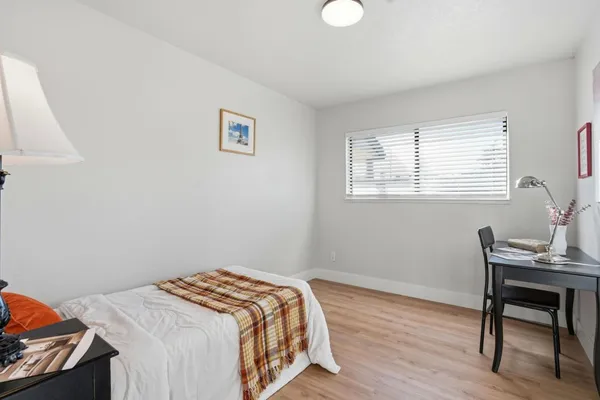 a bedroom with a bed and a desk