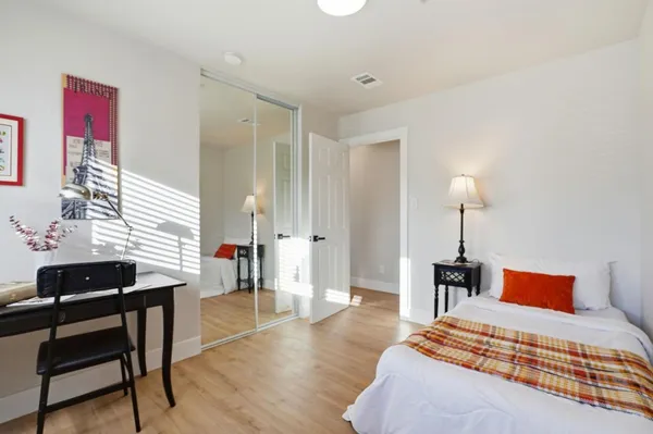 a bedroom with a bed and a table