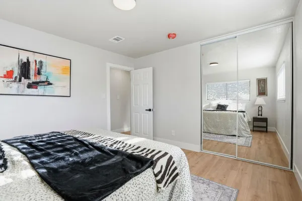 a bedroom with a bed and a view of kitchen