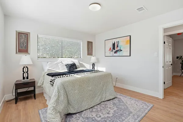 a bedroom with furniture and a window