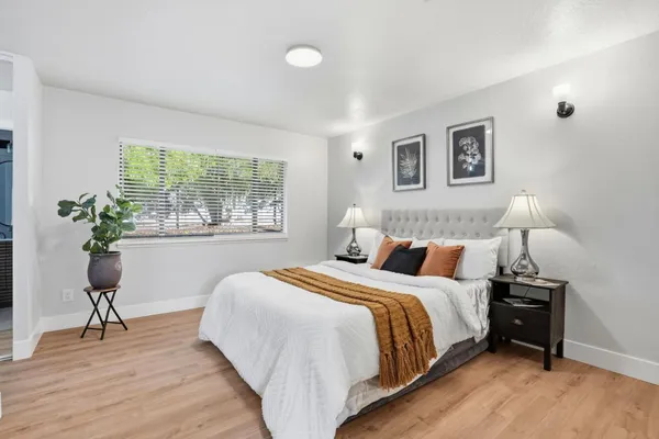 a bedroom with a bed and a potted plant