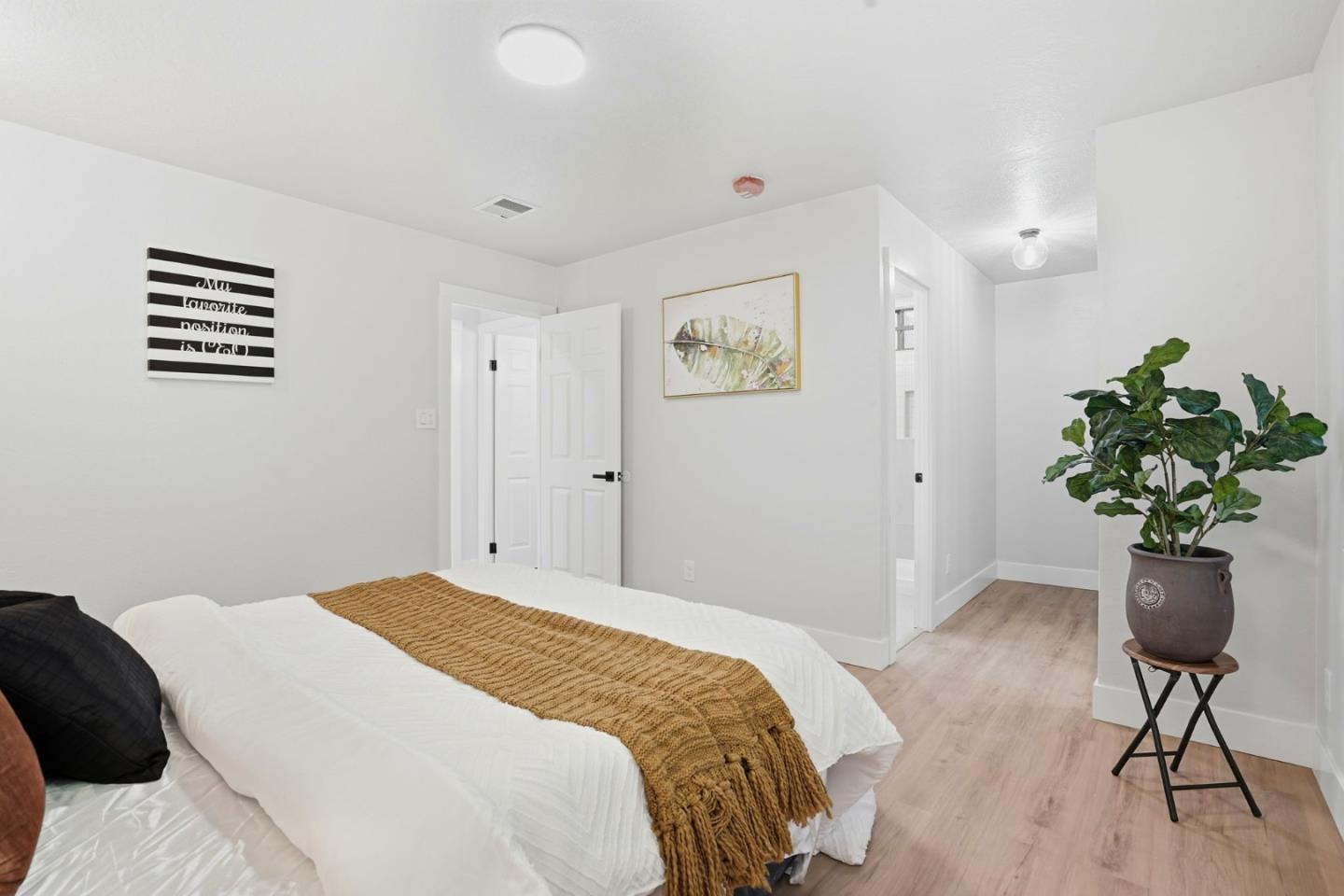 221 Pinon Avenue Pinole, CA 94564 - Photo 22 of 31 a bedroom with a bed and a potted plant