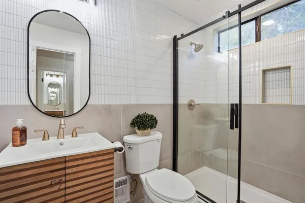 a bathroom with a sink toilet and shower