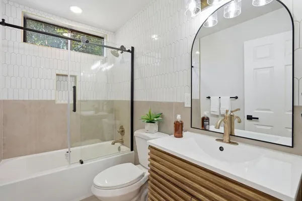 a bathroom with a sink a toilet and a mirror