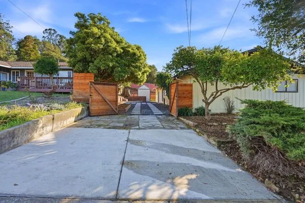a view of a backyard with swimming pool