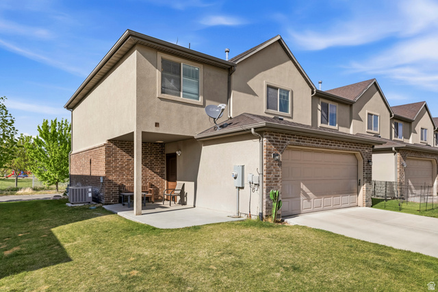 1165 West 100 South Springville, UT 84663 - Photo 14 of 28 Traditional-style house featuring stucco siding, a front lawn, brick siding, and an attached garage