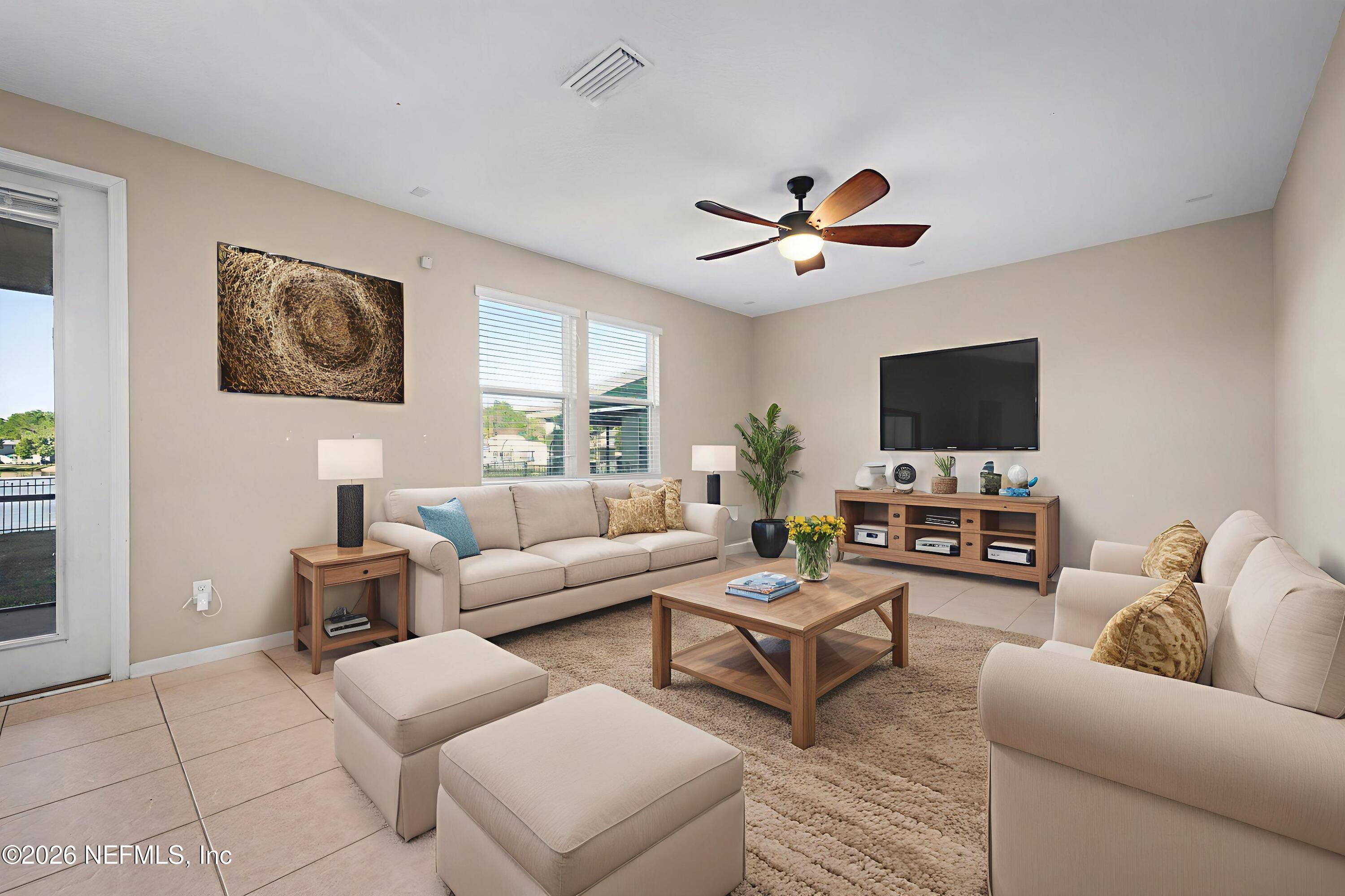 13697 Goodson Place Jacksonville, FL 32226 - Photo 13 of 28 a living room with furniture a ceiling fan and a window