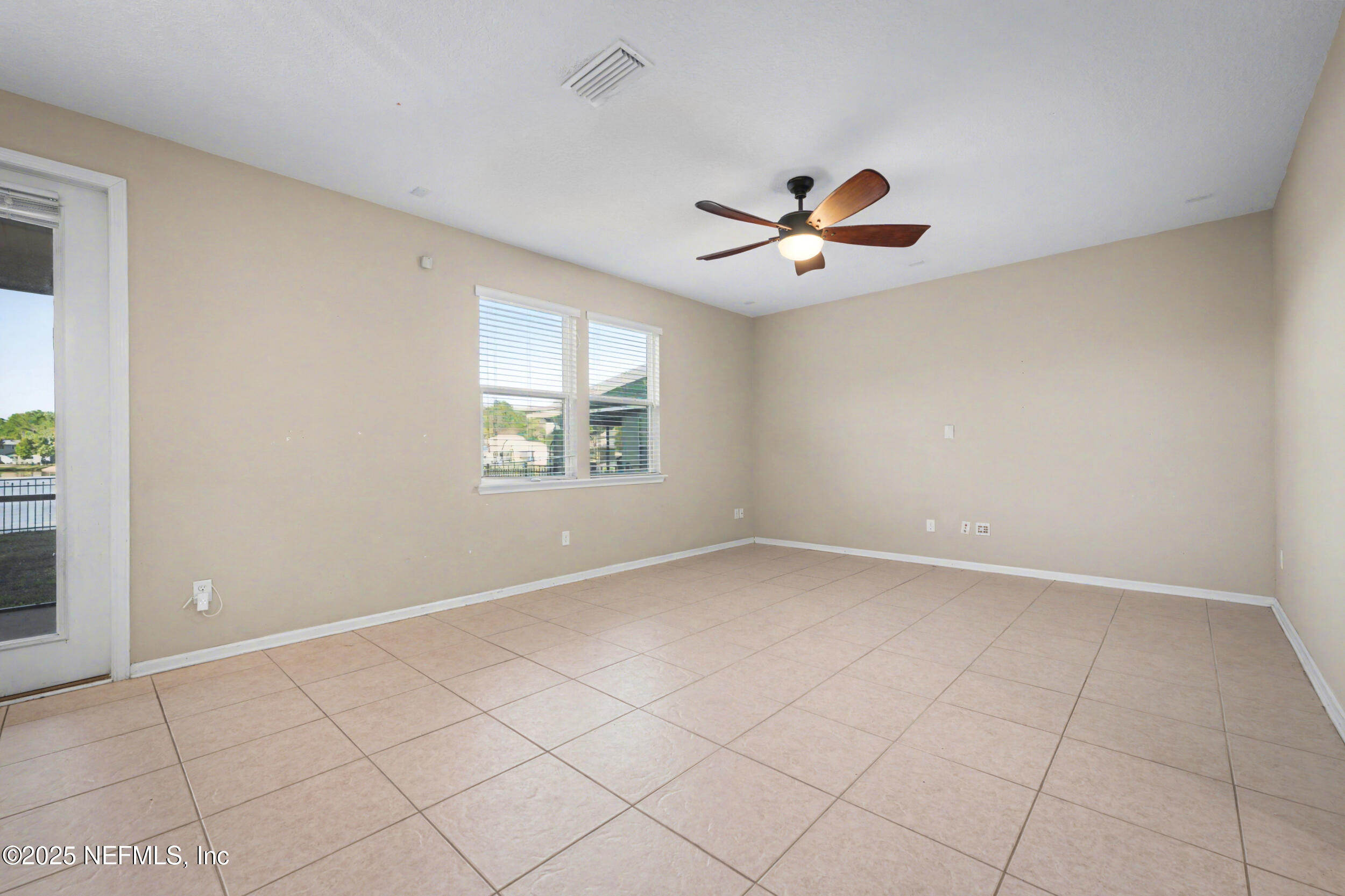 13697 Goodson Place Jacksonville, FL 32226 - Photo 14 of 28 an empty room with windows and chandelier fan