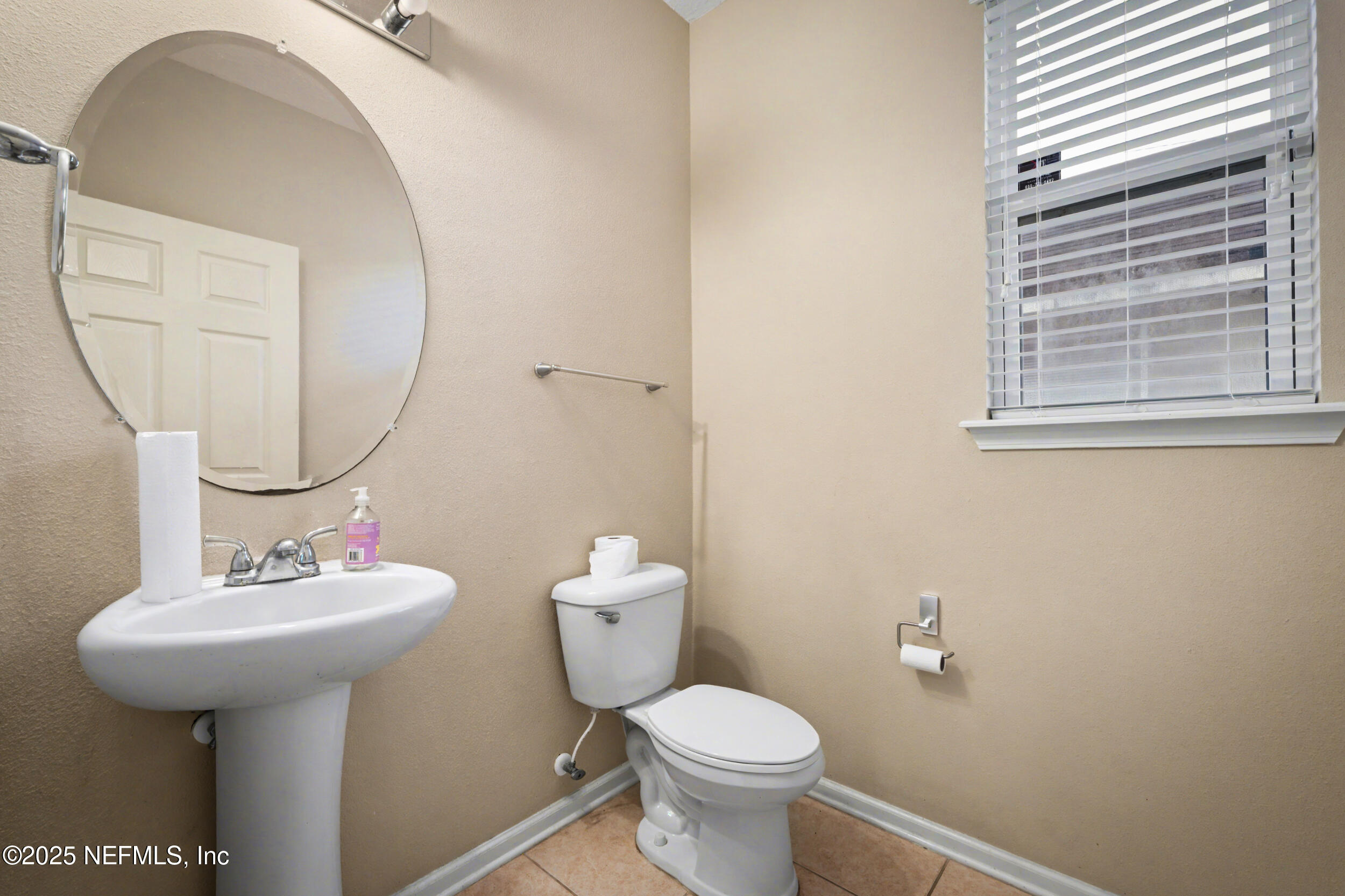 13697 Goodson Place Jacksonville, FL 32226 - Photo 15 of 28 a bathroom with a sink toilet and a mirror