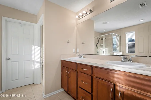 a bathroom with a granite countertop sink mirror and double