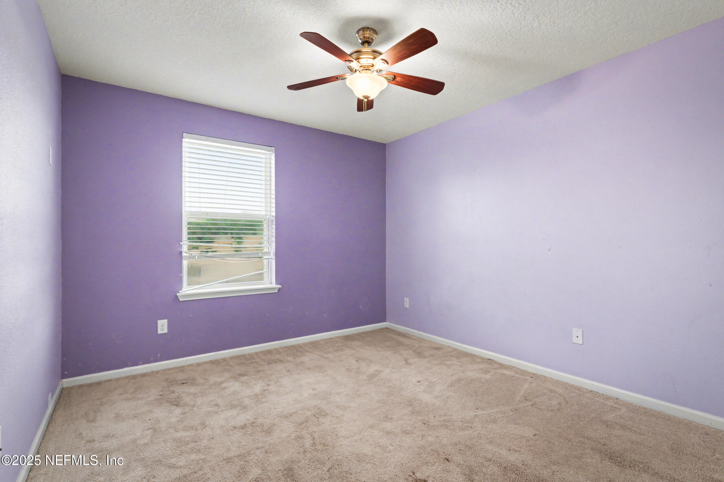 13697 Goodson Place Jacksonville, FL 32226 - Photo 22 of 28 an empty room with a window and a fan
