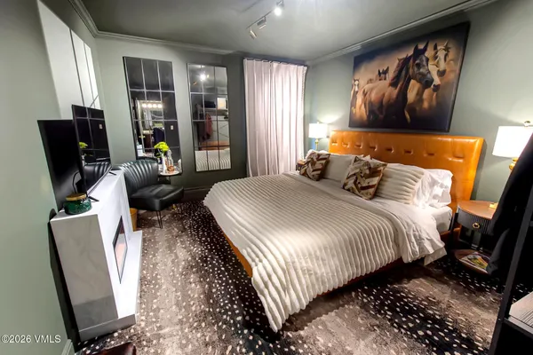 a bedroom with bed and glass door