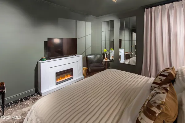 a bedroom with a bed and a flat screen tv