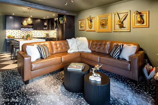 a living room with furniture and a chandelier