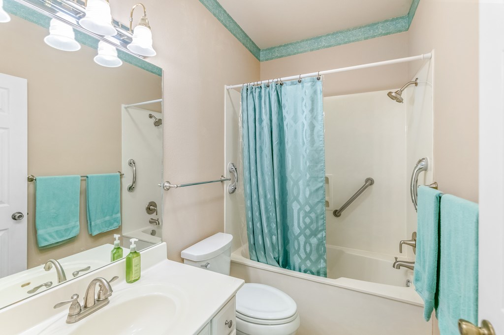 225 Los Cedros Loop Kerrville, TX 78028 - Photo 18 of 27 a bathroom with a sink a toilet and shower