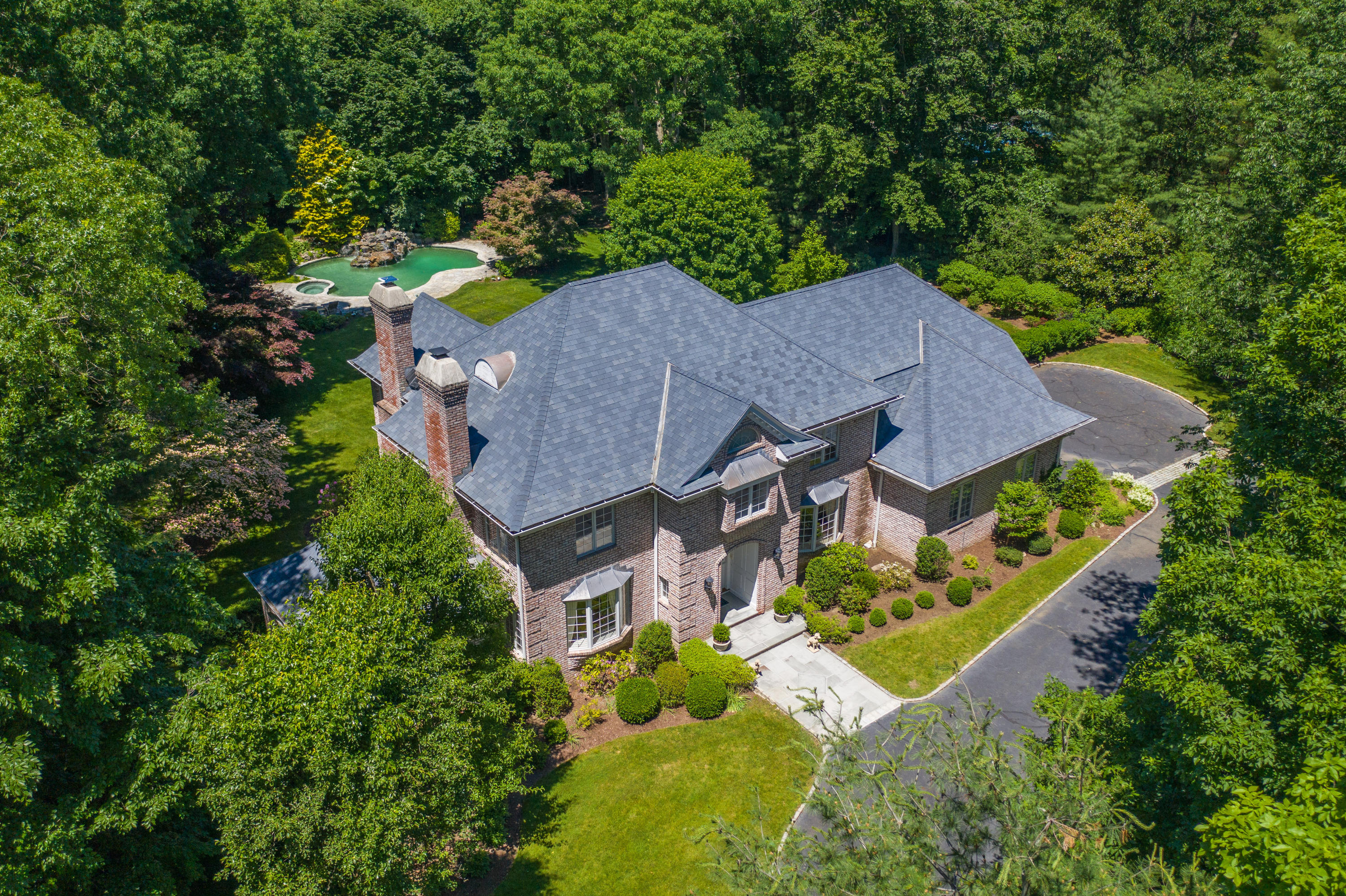 731 Hollow Tree Ridge Road Darien, CT 06820 - Photo 1 of 43 an aerial view of a house with a garden