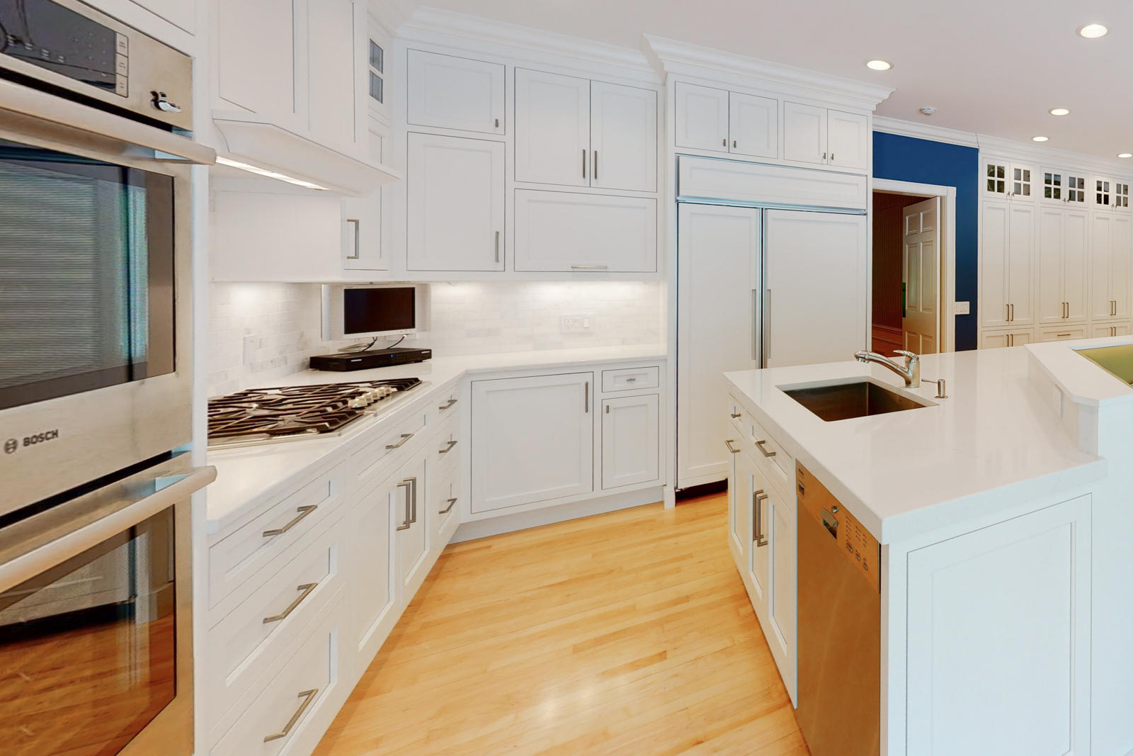 731 Hollow Tree Ridge Road Darien, CT 06820 - Photo 21 of 43 a kitchen with white cabinets and appliances