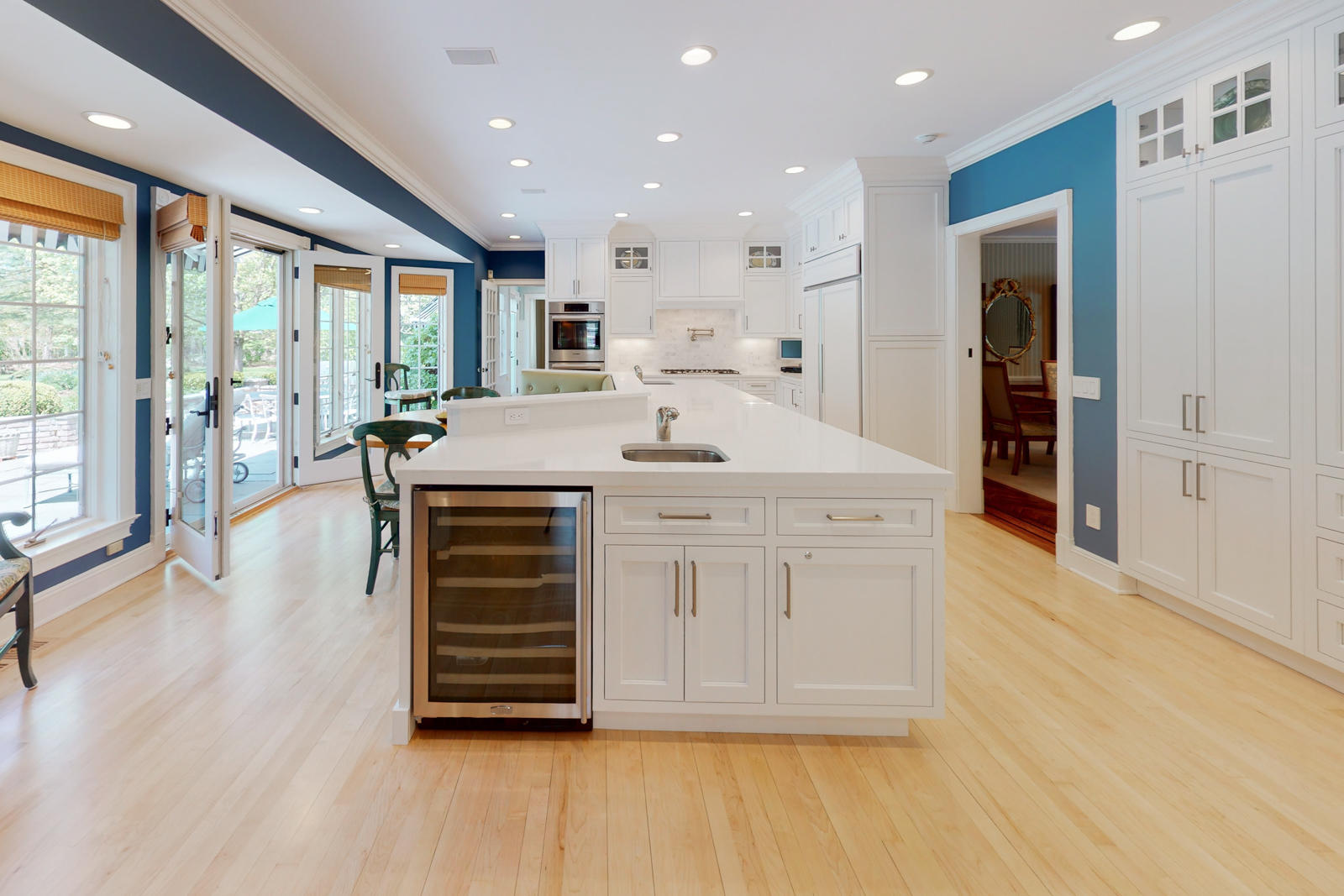 731 Hollow Tree Ridge Road Darien, CT 06820 - Photo 22 of 43 a room with kitchen island stainless steel appliances a large window and wooden floor