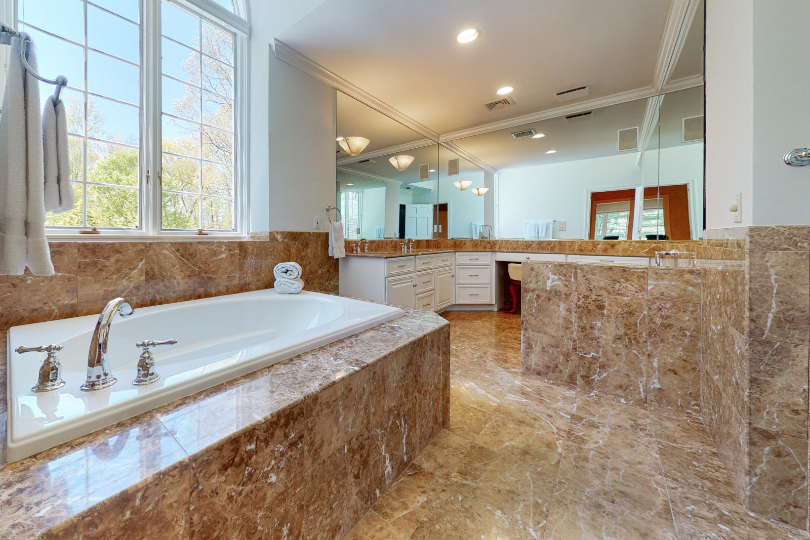 731 Hollow Tree Ridge Road Darien, CT 06820 - Photo 27 of 43 a large bathroom with a tub a sink and a large window