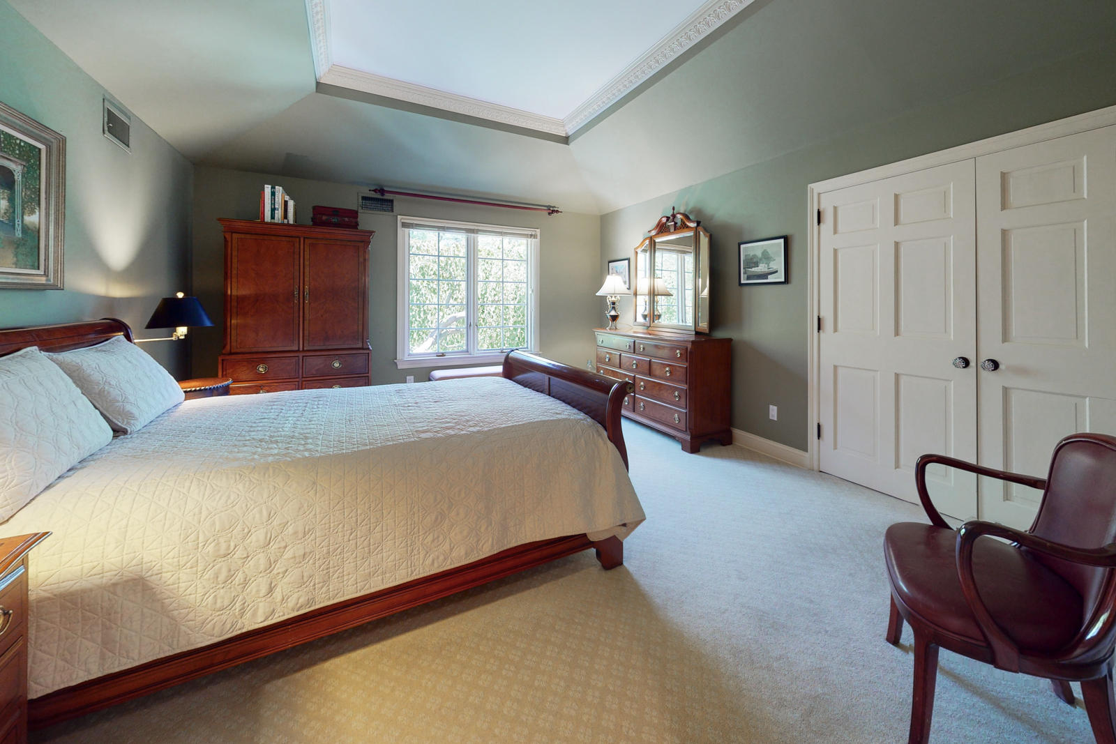 731 Hollow Tree Ridge Road Darien, CT 06820 - Photo 34 of 43 a bed sitting in a spacious bedroom next to a window and chair