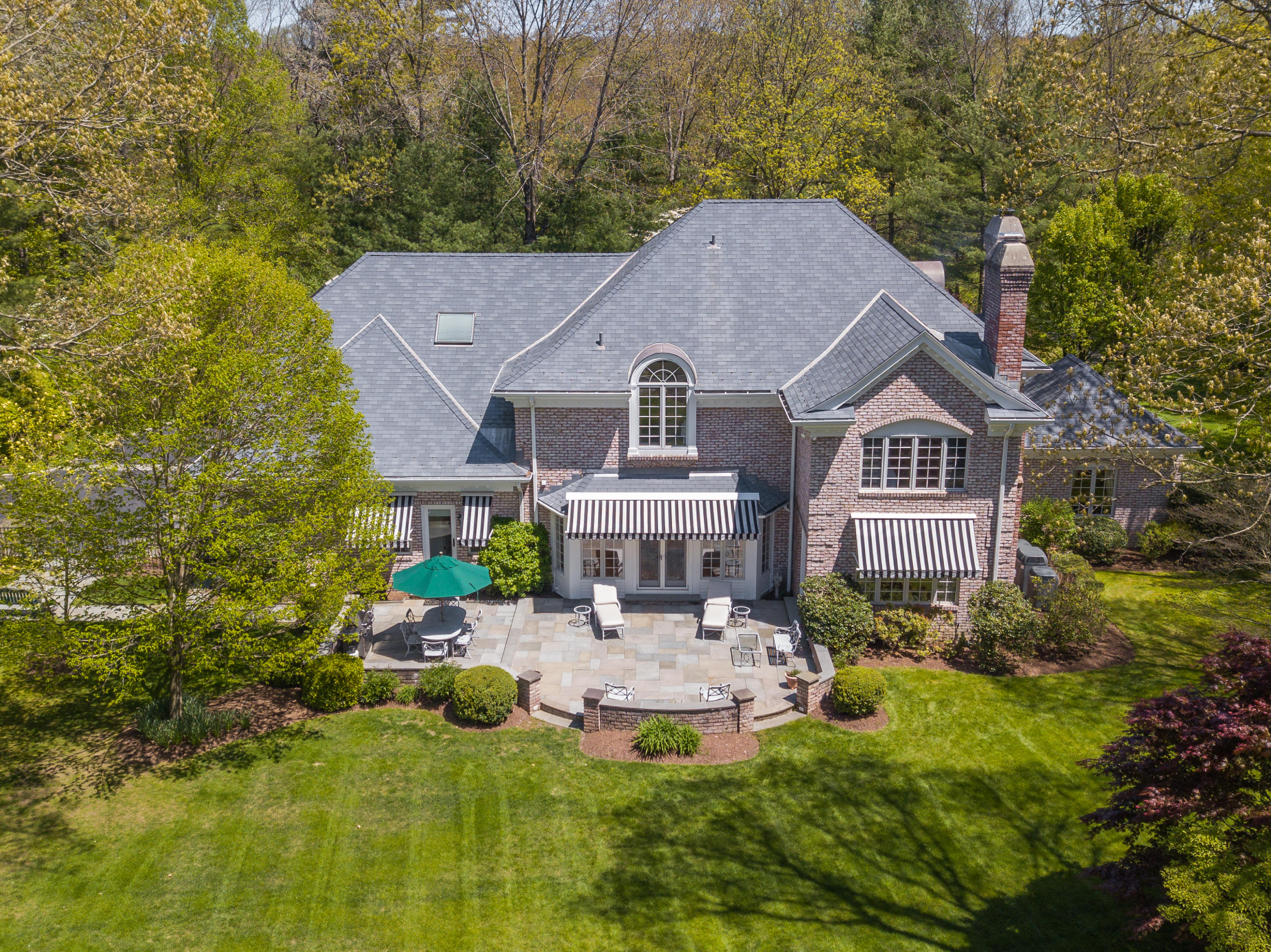 731 Hollow Tree Ridge Road Darien, CT 06820 - Photo 43 of 43 a aerial view of a house with a yard table and chairs
