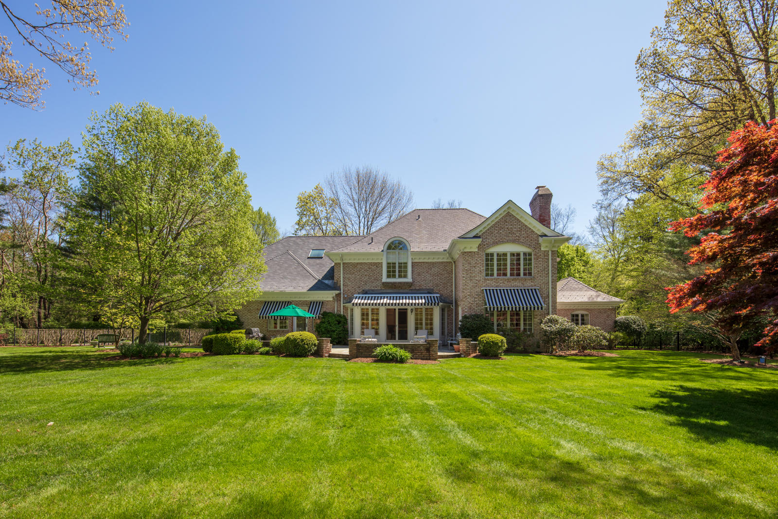 731 Hollow Tree Ridge Road Darien, CT 06820 - Photo 8 of 43 a front view of house with yard and green space